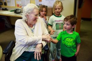 Marie Loken says goodbye to Finn Boatman, 4, after the group made sack lunches for the homeless. The Intergenerational Learning Center is popular with young families looking to open their children to the realities of aging. 