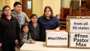 The family of Max Villatoro, an Iowa City pastor, stands inside the sanctuary of Trinity United Methodist Church in Des Moines on Tuesday, March 10, 2015. Villatoro was detained by Immigration and Customs Enforcement on March 3 and, at the time this photograph was taken, had not yet been deported to Honduras. From left: daughter Edna, 13, son Anthony, 15, daughter Aileen, 7, daughter Angela, 10, and wife Gloria. The boxes held signed petitions, later delivered to ICE in Omaha, Neb., that requested further review of Villatoro's case in lieu of immediate deportation. The request was not honored.