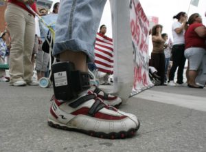 A marcher wears an ankle monitoring device during an immigration reform march through the streets of Postville on Sunday, July 27, 2008. The women fitted with the ankle devices wore them for roughly 19 months. (Jim Slosiarek/The Gazette)