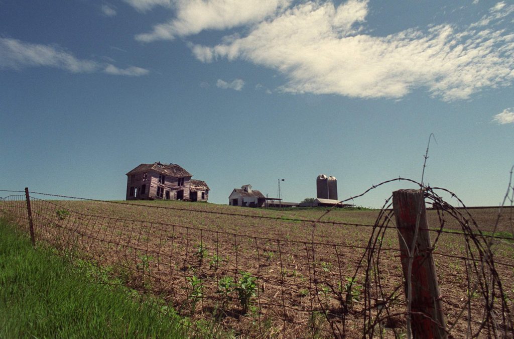 Suicide Farmer Suicides - An abandoned farmhouse sits on a hillside in rural Iowa County.