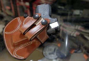 Gun - A .380 caliber handgun in a concealment holster.