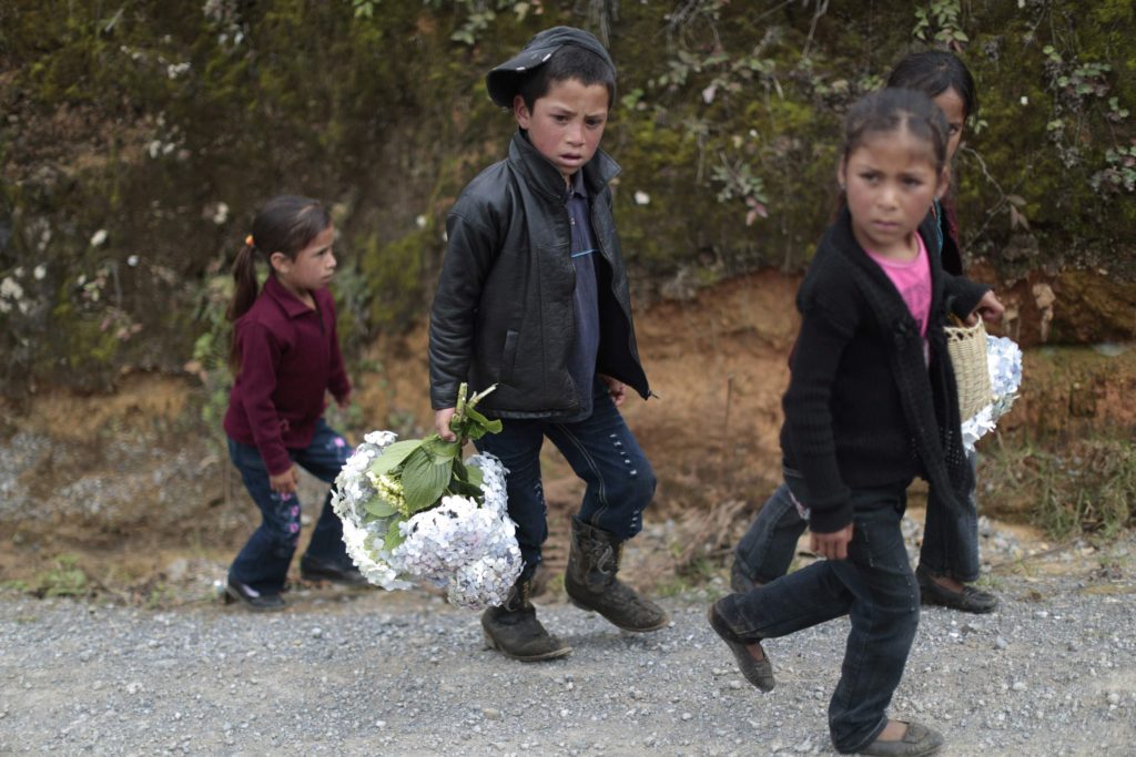 Children accompanying the funeral procession of teenage migrant Gilberto Francisco Ramos Juarez make their way to the cemetery, in San Jose Las Flores, Chiantla, in the Huehuetenango region, north of Guatemala City, July 12, 2014. Ramos Juarez's body was found in the Rio Grande Valley of southern Texas, less than a mile from the U.S.-Mexico border. An autopsy revealed no signs of trauma and authorities believe Ramos Juarez died of heat stroke. Differing media reports have stated Ramos Juarez's age as 14 or 15 years.
