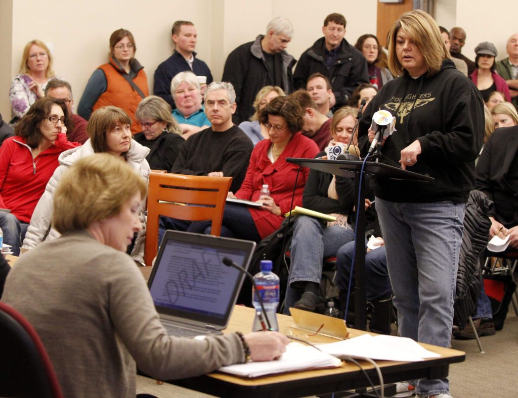 Board member Marla Swesey (left) takes notes as Amy Johnson of North Liberty raises concerns during a ‘listening post’ held by members of the ICCSD Board to discuss the district’s diversity plan on Jan. 12, 2013. 