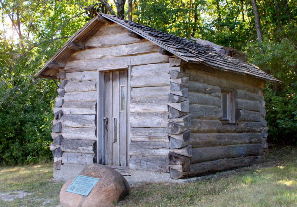 A replica of the first schoolhouse built in the 1890s in what was then known as Iowa Territory sits beside the Mississippi River between Keokuk and Montrose in Lee County. The tiny structure was 10-feet by 12-feet and, because building supplies were scarce, was held together by mud.