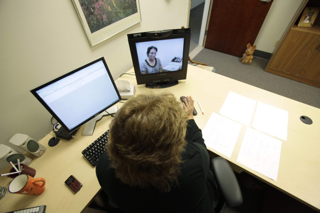 A doctor, foreground, in Des Moines, and a nurse in another city, demonstrate a telemedicine program with which Planned Parenthood doctors can remotely prescribe abortion-inducing medicines. (File photo)