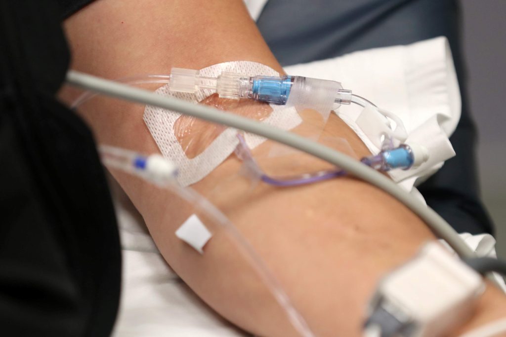 Prudent Layperson standard - A California man gets fluids in an IV as he lies on a bed with the flu in the emergency room at Palomar Medical Center in Escondido, California, U.S., January 18, 2018.